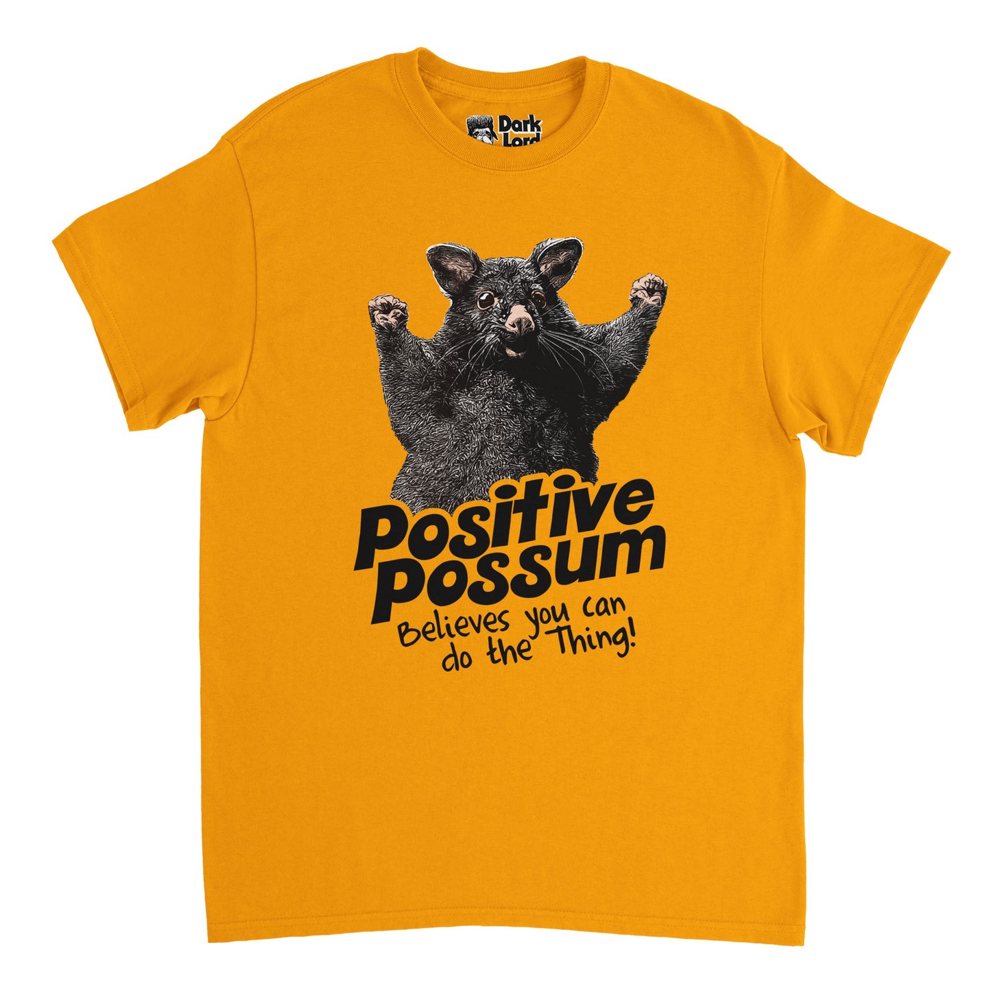 A retro, 70s style dark yellow colored t-shirt with an image of a possum with his little hands raised in fists, as if cheering someone on, and motivational text that says "Positive Possum Believes you can do the Thing!", referencing the popular positive possum internet meme originating from an image taken in Opotiki, New Zealand.