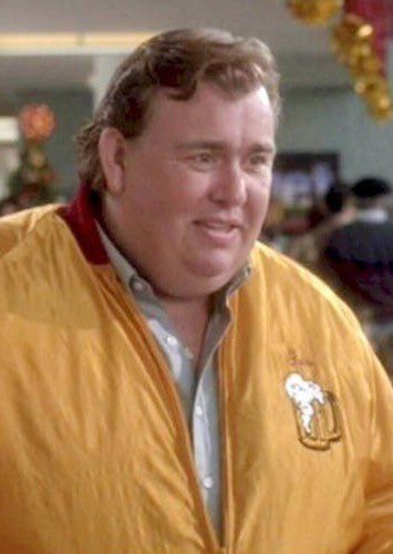 A man wearing a yellow jacket with a beer logo on it, smiling at the camera.